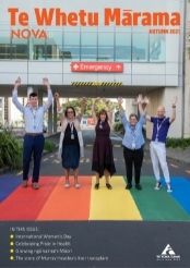 five people on a rainbow coloured pedestrian crossing